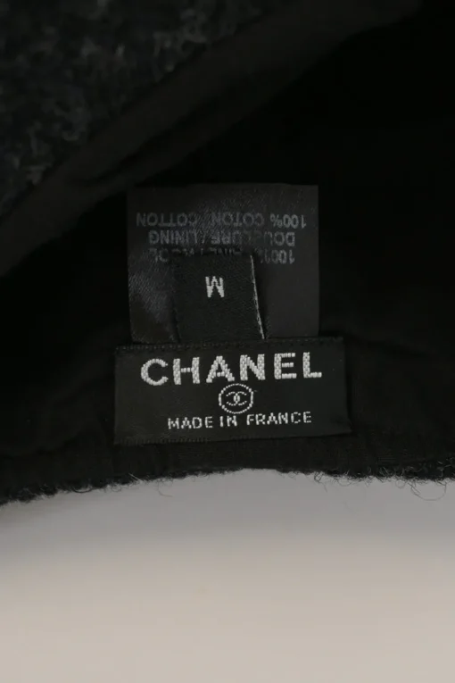 Black wool felt newsboy cap with metallic Coco Mark plaque appliqué