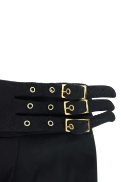 Black wool high waisted casual pants with folded hem and gold buckles.