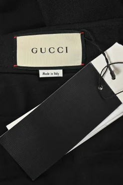 Black wool-mohair blend pull-on high-rise wide-leg tailored trousers with extended tab closure and turn-up cuffs