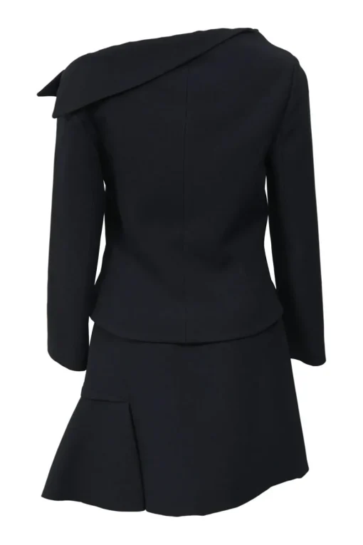 Black wool-silk blend two-piece skirt suit featuring asymmetric spread collar tailored jacket and drop-waist flounce mini skirt
