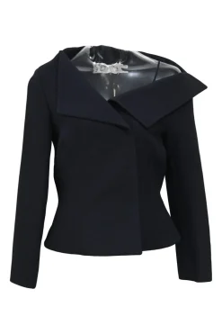 Black wool-silk blend two-piece skirt suit featuring asymmetric spread collar tailored jacket and drop-waist flounce mini skirt