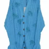 Blue cotton cable-knit button-front cardigan with flounce cuffs and tonal floral appliqués