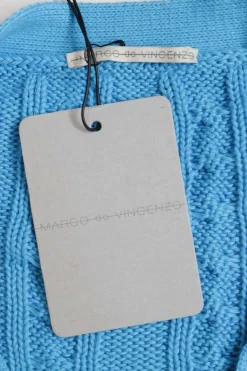 Blue cotton cable-knit button-front cardigan with flounce cuffs and tonal floral appliqués