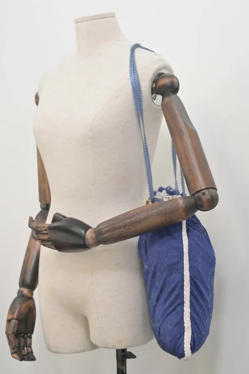Blue embellished abstract jacquard drawstring shoulder bag with contrast bead broderie appliqué