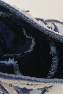 Blue embellished abstract jacquard drawstring shoulder bag with contrast bead broderie appliqué