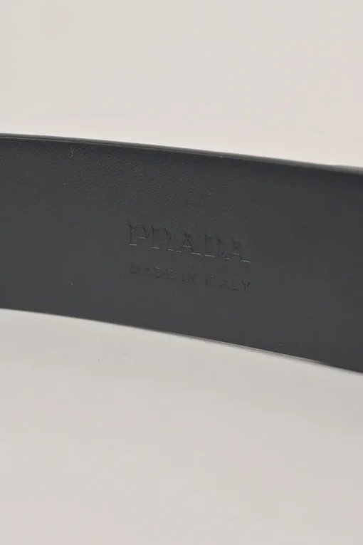 Blue Saffiano leather belt featuring large silver-tone engraved logo