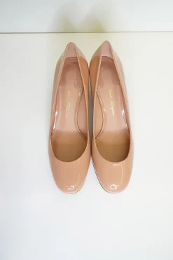 Blush peach almond toe pumps with a stacked gold-tone sculpted block heel
