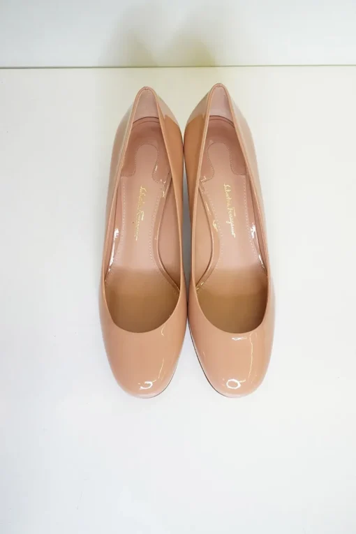 Blush peach almond toe pumps with a stacked gold-tone sculpted block heel