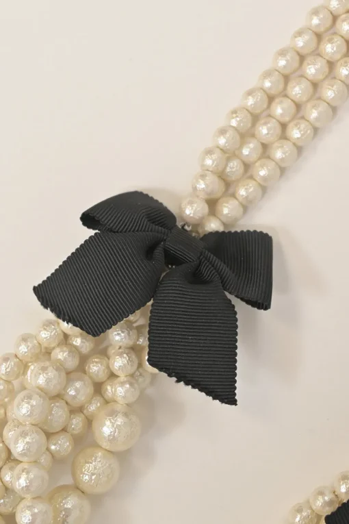 Bow-embellished resin multi-strand faux pearl necklace with lobster clasp closure