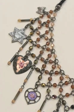 Brass charm festoon ribbon-tie necklace