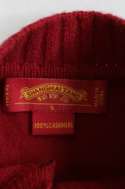 Brick red cashmere mock neck cardigan with frog button fastening at centre front