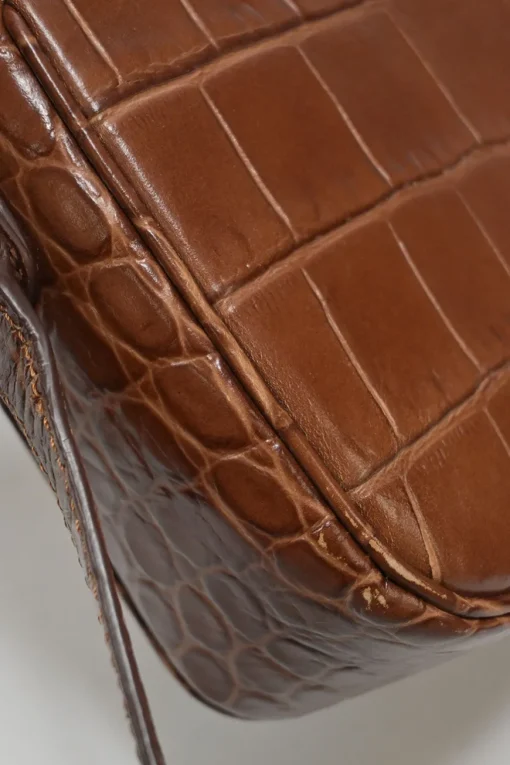 Brown croc-embossed calfskin tassel flap bag with adjustable shoulder strap