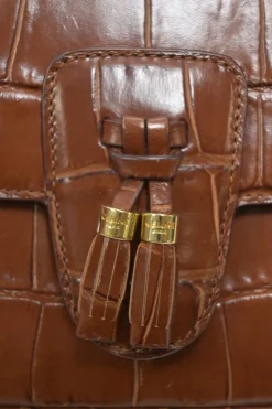 Brown croc-embossed calfskin tassel flap bag with adjustable shoulder strap