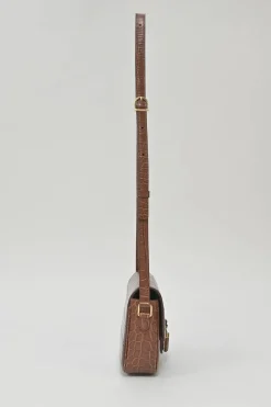Brown croc-embossed calfskin tassel flap bag with adjustable shoulder strap