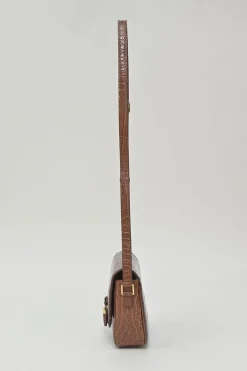 Brown croc-embossed calfskin tassel flap bag with adjustable shoulder strap