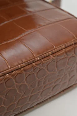 Brown croc-embossed calfskin tassel flap bag with adjustable shoulder strap