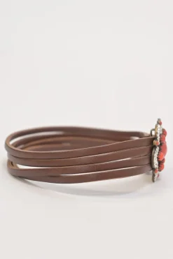 Brown leather choker featuring crystal and enamel-embellished flower pendant