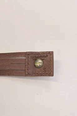Brown leather choker featuring crystal and enamel-embellished flower pendant