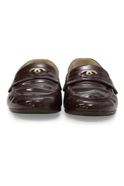 Brown patent leather round-toe slip-on penny loafers with gold-tone metallic Coco Mark vamp appliqué