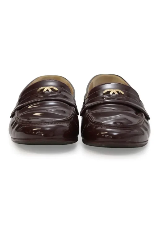 Brown patent leather round-toe slip-on penny loafers with gold-tone metallic Coco Mark vamp appliqué