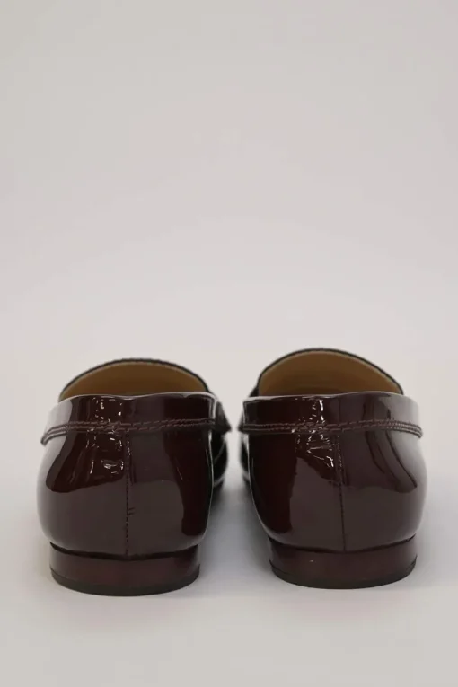 Brown patent leather round-toe slip-on penny loafers with gold-tone metallic Coco Mark vamp appliqué