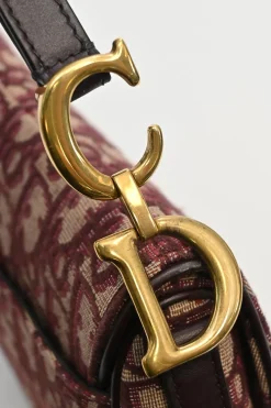 Burgundy and ecru Oblique monogram jacquard fabric and leather saddle bag with detachable shoulder strap