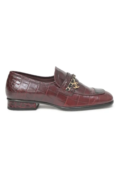 Burgundy croc-embossed leather slip-on loafers featuring chainlink Coco Mark charm vamp appliqué