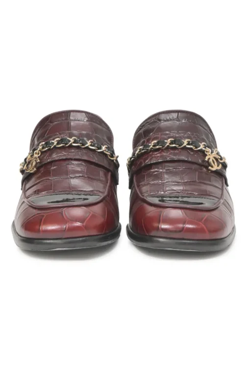 Burgundy croc-embossed leather slip-on loafers featuring chainlink Coco Mark charm vamp appliqué