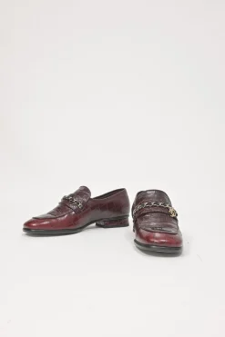 Burgundy croc-embossed leather slip-on loafers featuring chainlink Coco Mark charm vamp appliqué