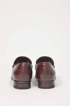 Burgundy croc-embossed leather slip-on loafers featuring chainlink Coco Mark charm vamp appliqué