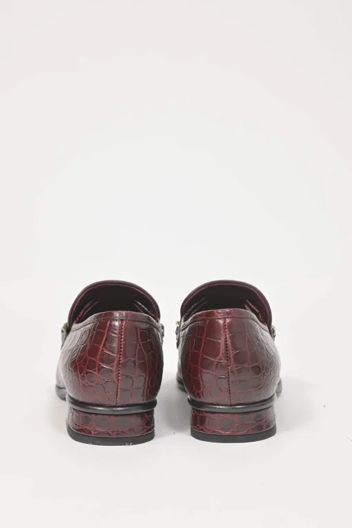Burgundy croc-embossed leather slip-on loafers featuring chainlink Coco Mark charm vamp appliqué