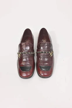 Burgundy croc-embossed leather slip-on loafers featuring chainlink Coco Mark charm vamp appliqué