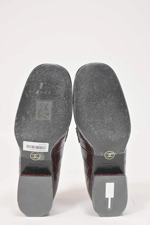 Burgundy croc-embossed leather slip-on loafers featuring chainlink Coco Mark charm vamp appliqué