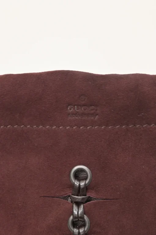 Burgundy grommet-embellished suede drawstring bucket pouch