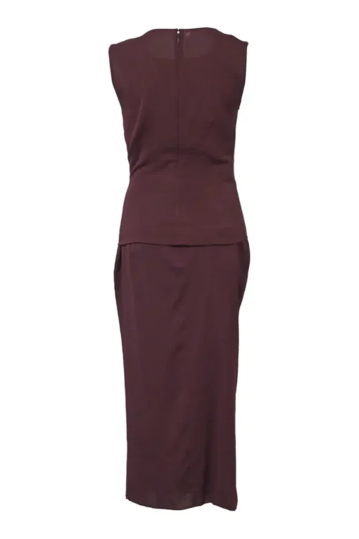 Burgundy two-piece skirt suit featuring sleeveless blouse and midi pencil skirt