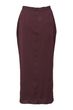 Burgundy two-piece skirt suit featuring sleeveless blouse and midi pencil skirt