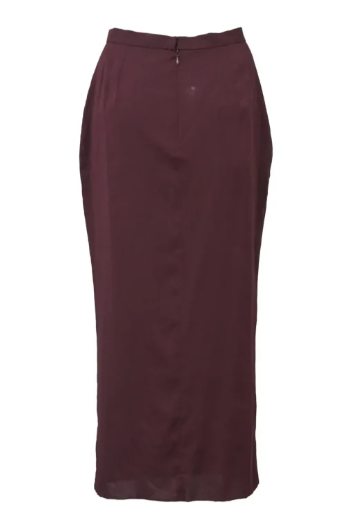 Burgundy two-piece skirt suit featuring sleeveless blouse and midi pencil skirt