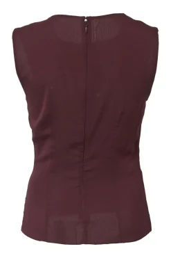 Burgundy two-piece skirt suit featuring sleeveless blouse and midi pencil skirt