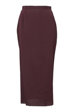 Burgundy two-piece skirt suit featuring sleeveless blouse and midi pencil skirt