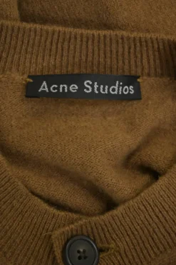 Camel wool button-front cardigan featuring signature leather face logo chest patch