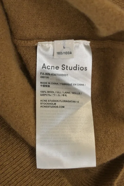 Camel wool button-front cardigan featuring signature leather face logo chest patch