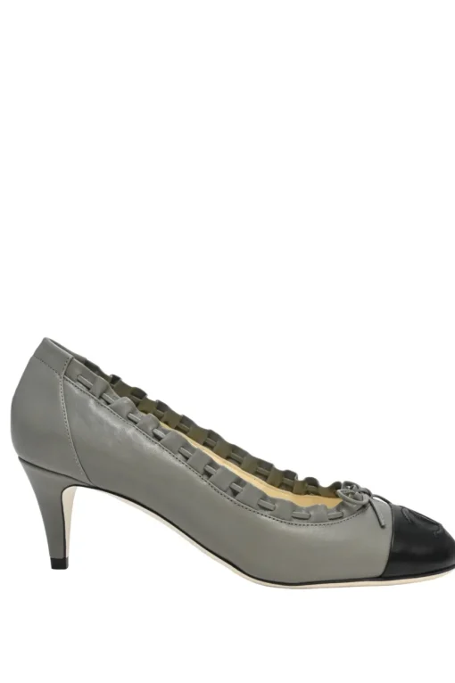 Charcoal leather round-toe ruffle edge cap toe pumps with topstitched Coco Mark detail