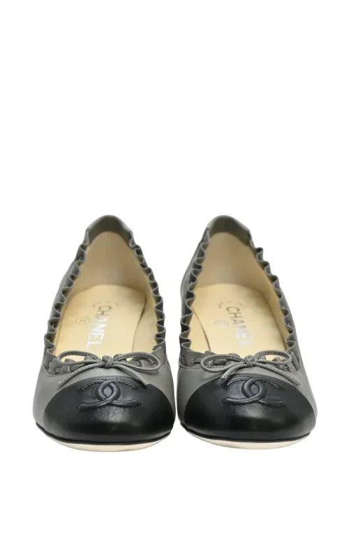 Charcoal leather round-toe ruffle edge cap toe pumps with topstitched Coco Mark detail
