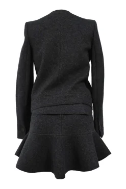 Charcoal merino melton three-piece set featuring collarless tailored jacket, strapless corset-style peplum top, and flounce mini skirt