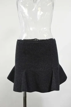 Charcoal merino melton three-piece set featuring collarless tailored jacket, strapless corset-style peplum top, and flounce mini skirt