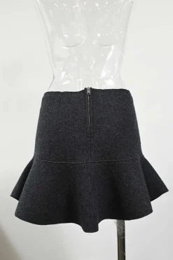Charcoal merino melton three-piece set featuring collarless tailored jacket, strapless corset-style peplum top, and flounce mini skirt