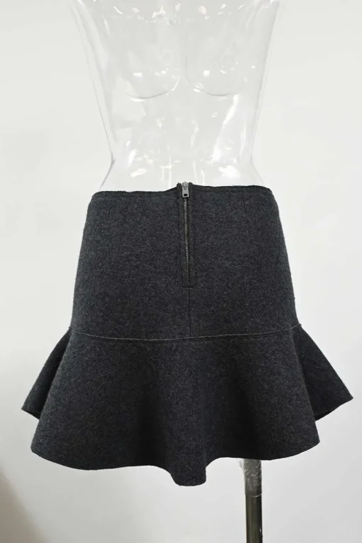 Charcoal merino melton three-piece set featuring collarless tailored jacket, strapless corset-style peplum top, and flounce mini skirt