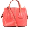 Coral leather satchel bag with visible top stitch and shoulder strap.