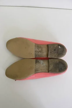 Coral pink and gold calfskin bow-embellished ballerinas with top-stitched Coco Mark cap toe