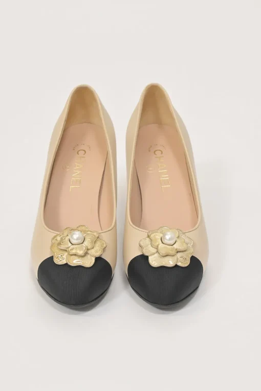 Cream leather and grosgrain round-toe camellia platform pumps with contrasting toe caps